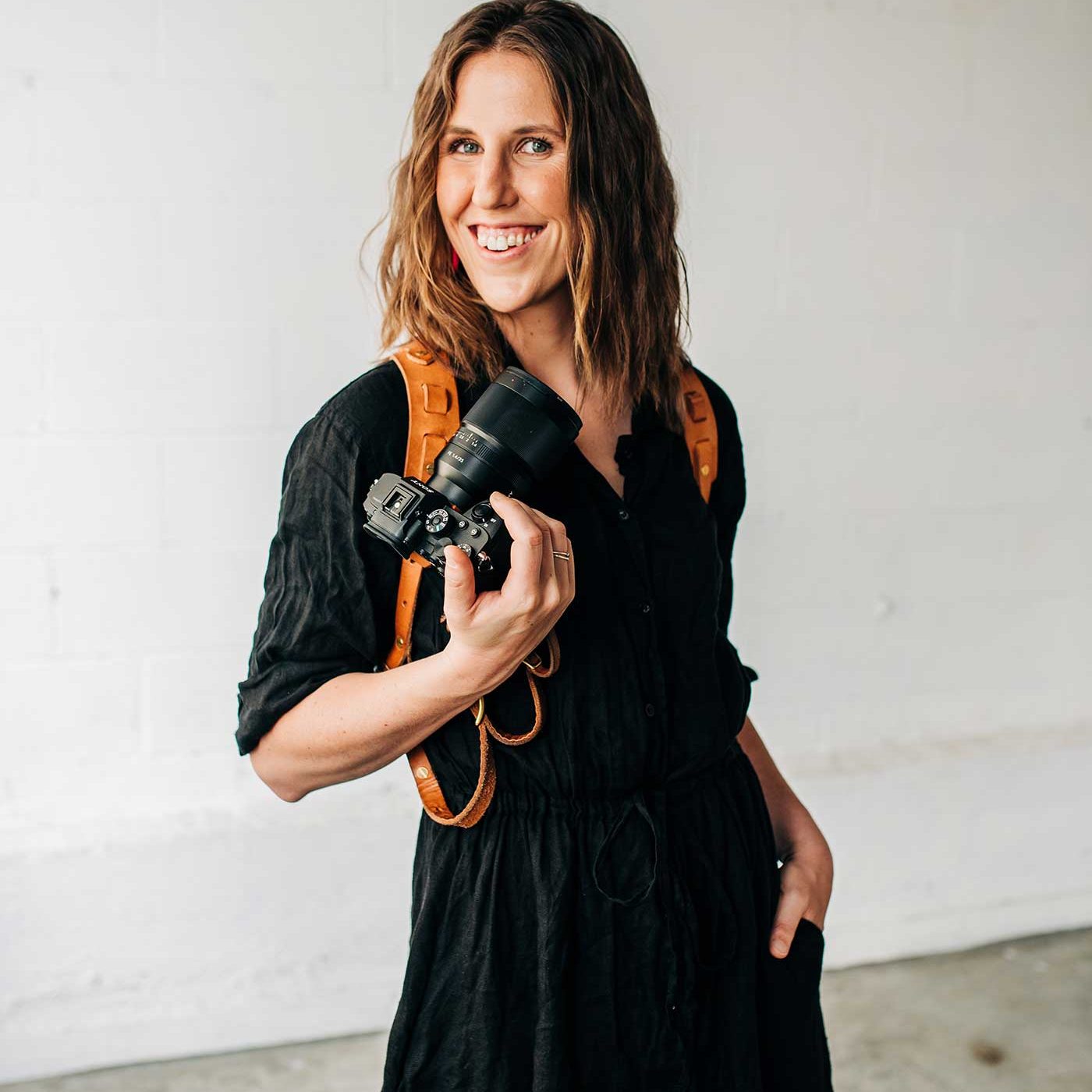 Dani Bartlett posing with her camera.